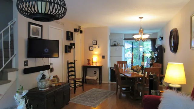 a dining room with furniture and a chandelier