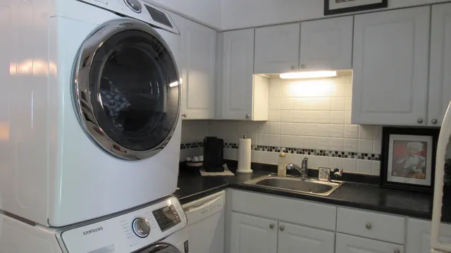 a kitchen with a sink and a washer dryer
