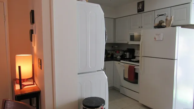 a kitchen with a refrigerator and a stove