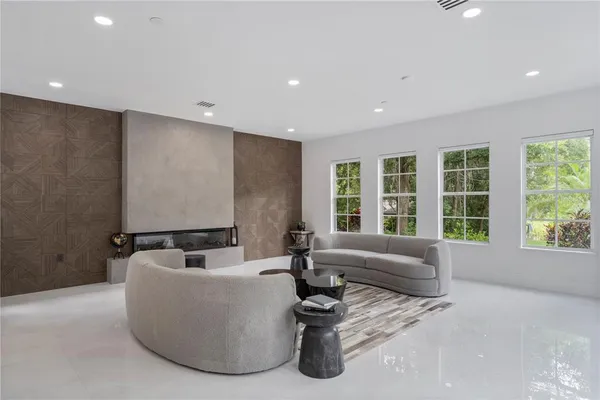 a living room with furniture and a potted plant