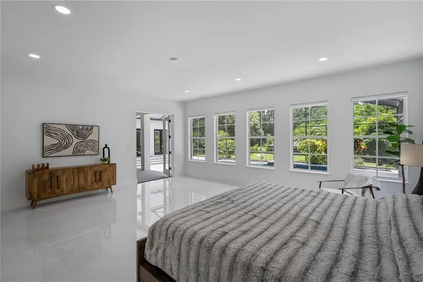 a spacious bedroom with a bed and a couch