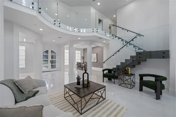 a living room with furniture and a potted plant