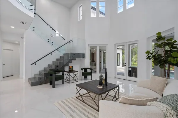 a kitchen with stainless steel appliances a stove a refrigerator and white cabinets with wooden floor