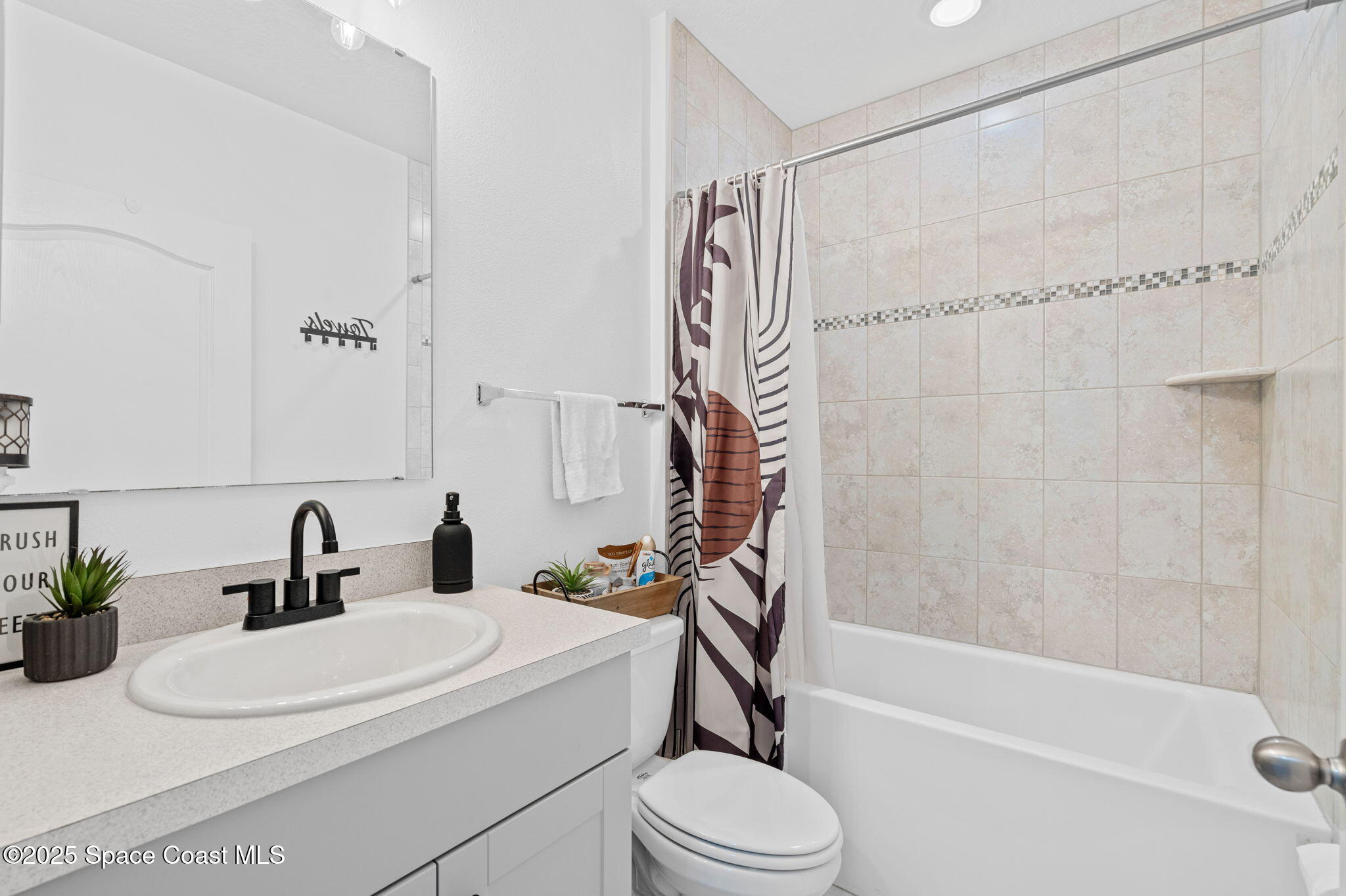 6162 Rena Avenue Cocoa, FL 32927 - Photo 22 of 42 a bathroom with a sink a toilet and shower