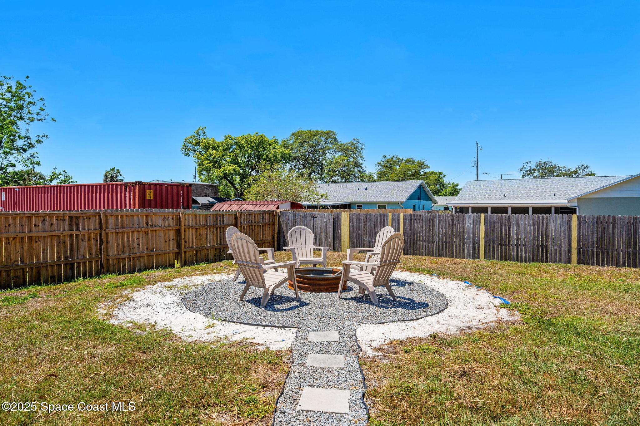 6162 Rena Avenue Cocoa, FL 32927 - Photo 31 of 42 a view of a patio with table and chairs with wooden fence
