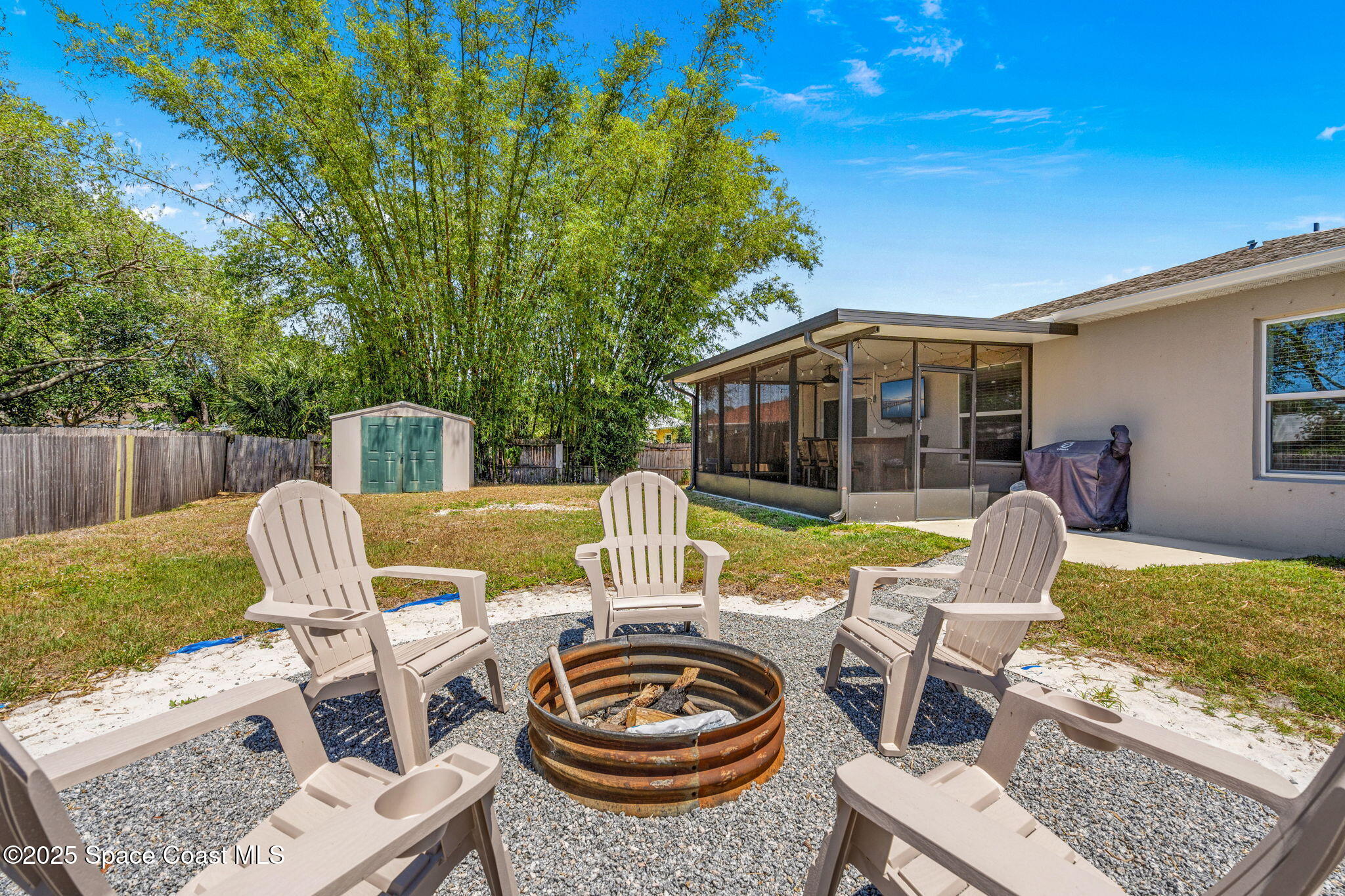 6162 Rena Avenue Cocoa, FL 32927 - Photo 32 of 42 a view of a patio with table and chairs with wooden floor and fence
