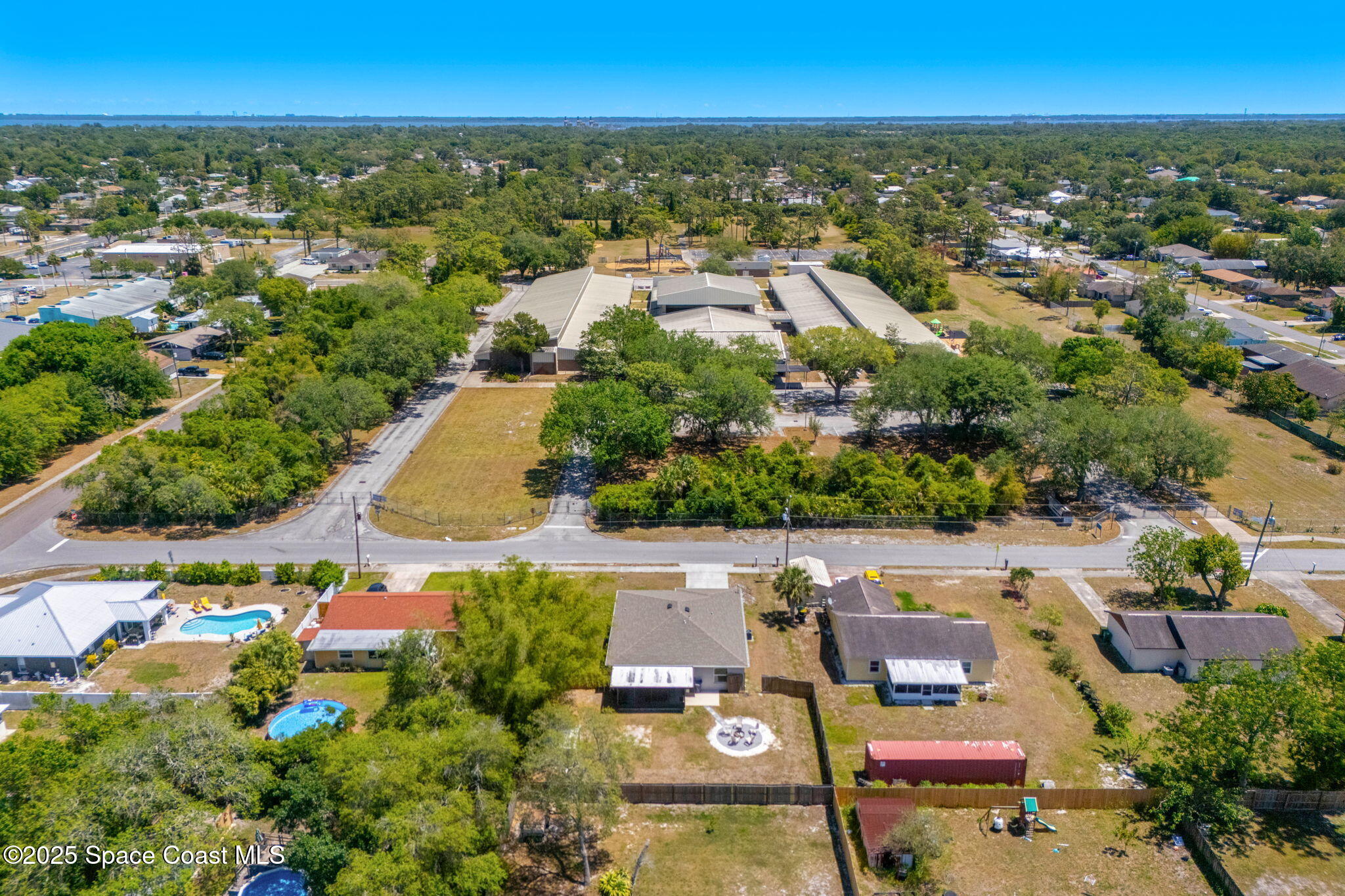 6162 Rena Avenue Cocoa, FL 32927 - Photo 38 of 42 an aerial view of residential houses with outdoor space and trees