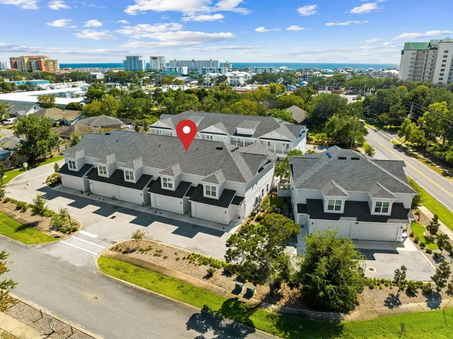 an aerial view of a house with a yard garage and lake view