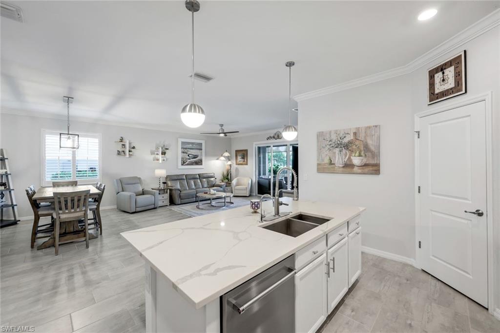 2193 Clementine Street Naples, FL 34120 - Photo 11 of 36 a large white kitchen with a table and chairs