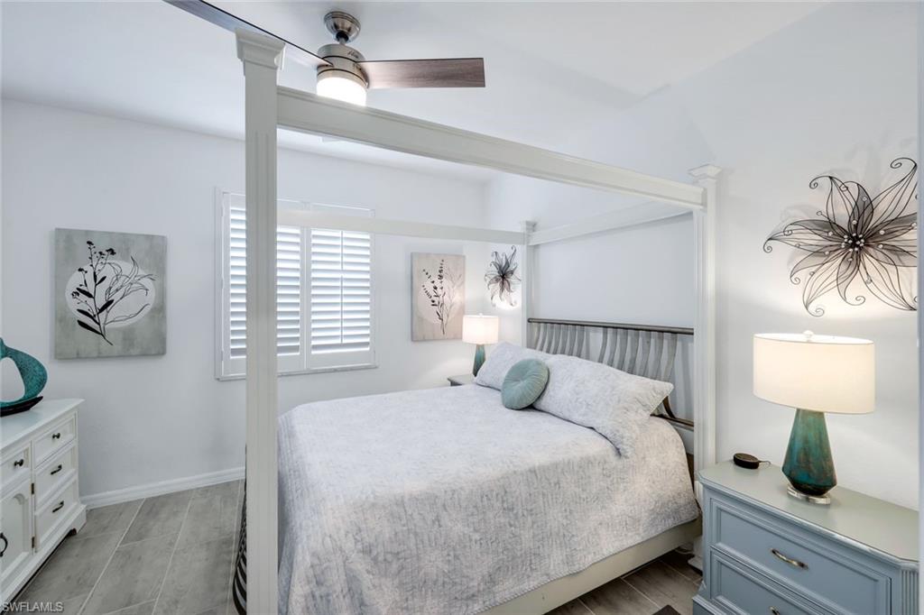 2193 Clementine Street Naples, FL 34120 - Photo 22 of 36 a bedroom with a bed and a window