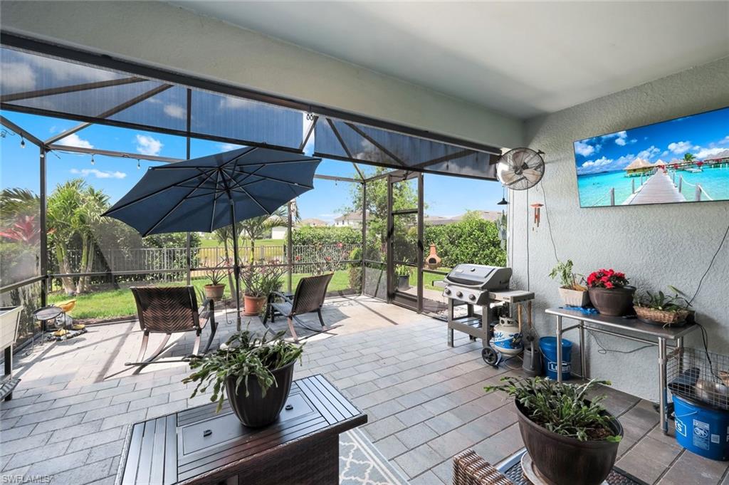 2193 Clementine Street Naples, FL 34120 - Photo 27 of 36 an outdoor space with furniture and umbrella