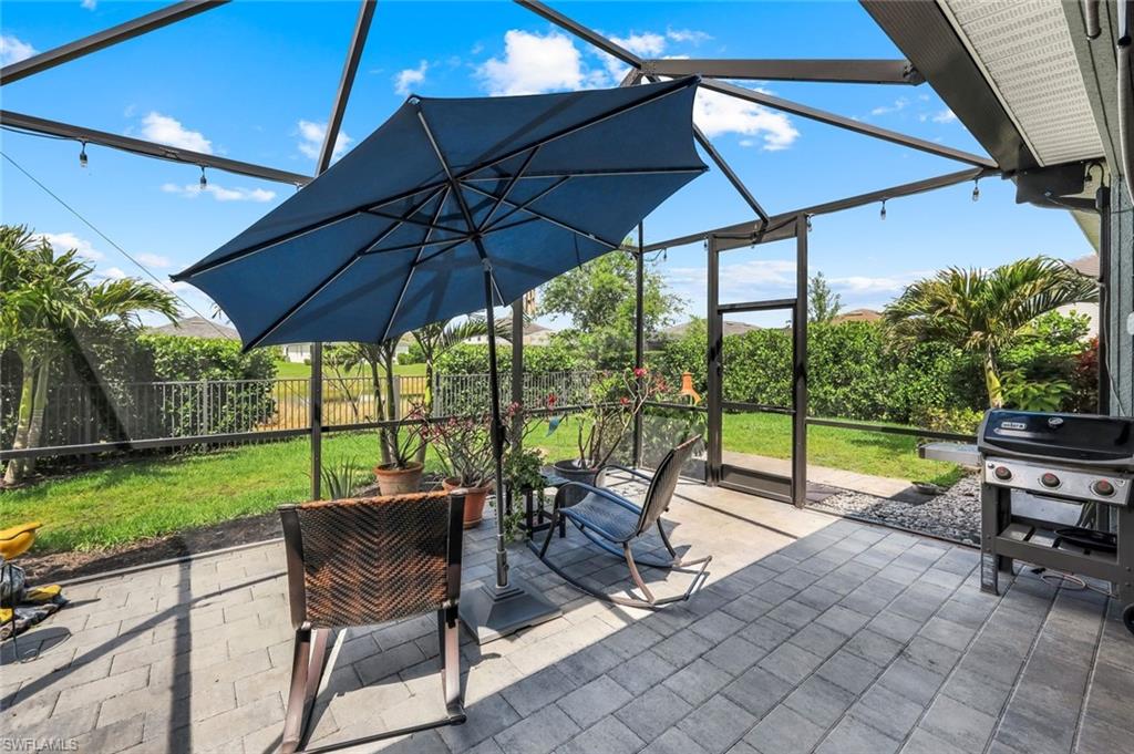 2193 Clementine Street Naples, FL 34120 - Photo 29 of 36 a view of a patio with a table chairs and a umbrella