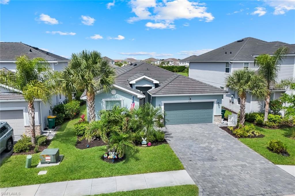 2193 Clementine Street Naples, FL 34120 - Photo 3 of 36 a front view of a house with garden