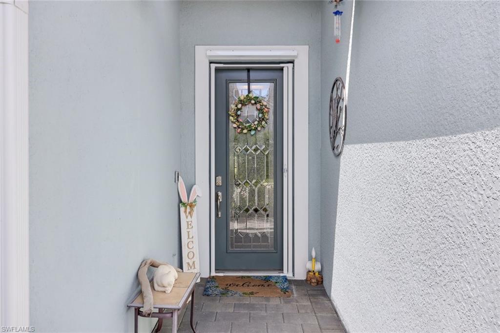 2193 Clementine Street Naples, FL 34120 - Photo 4 of 36 a view of a hallway with wooden floor and a dining room