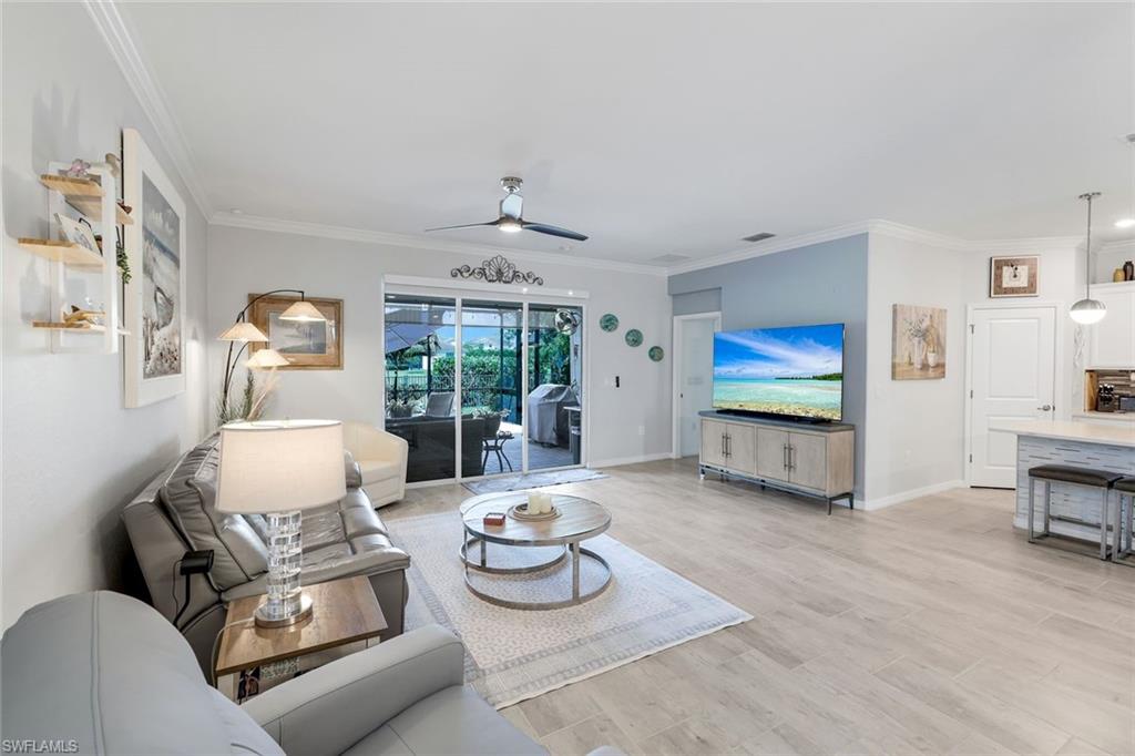 2193 Clementine Street Naples, FL 34120 - Photo 6 of 36 a living room with furniture and a flat screen tv