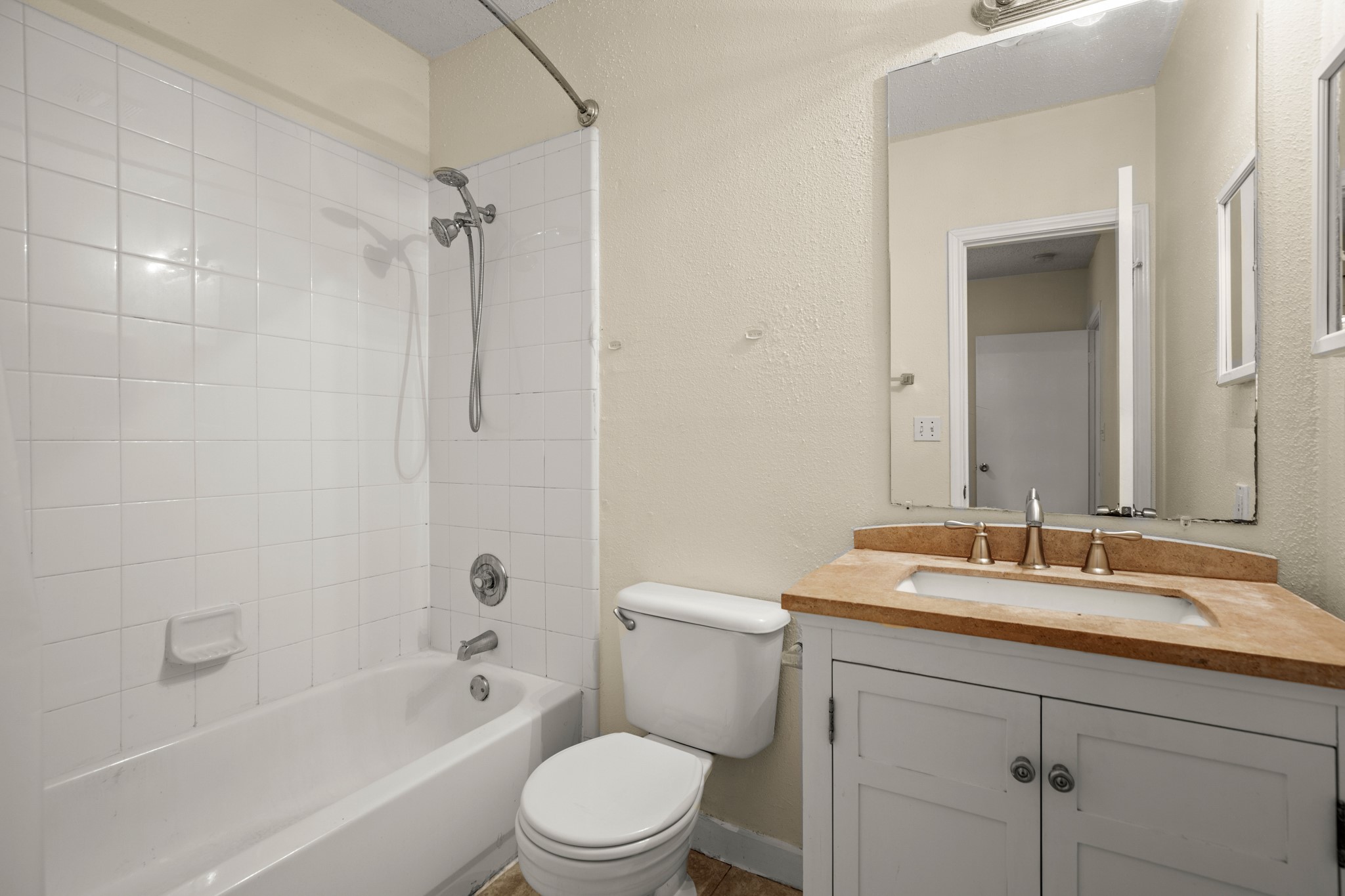 712 West 21st Street, Unit 101 Austin, TX 78705 - Photo 14 of 17 a bathroom with a sink a toilet and shower