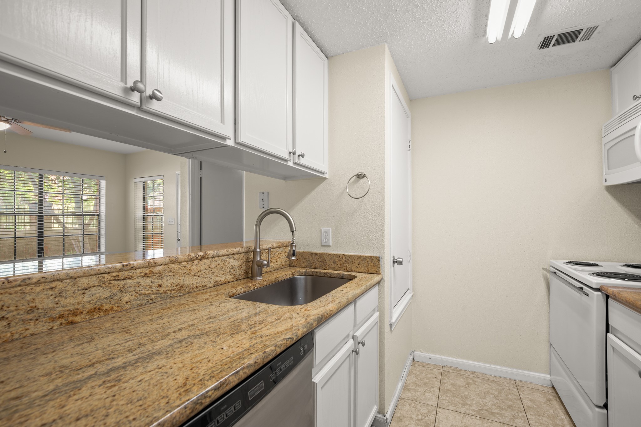 712 West 21st Street, Unit 101 Austin, TX 78705 - Photo 6 of 17 a kitchen with a sink and cabinets