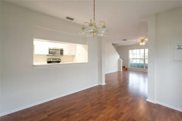 a view of a room with wooden floor and window