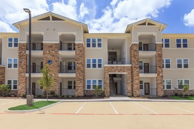 a front view of a building with a yard and garage