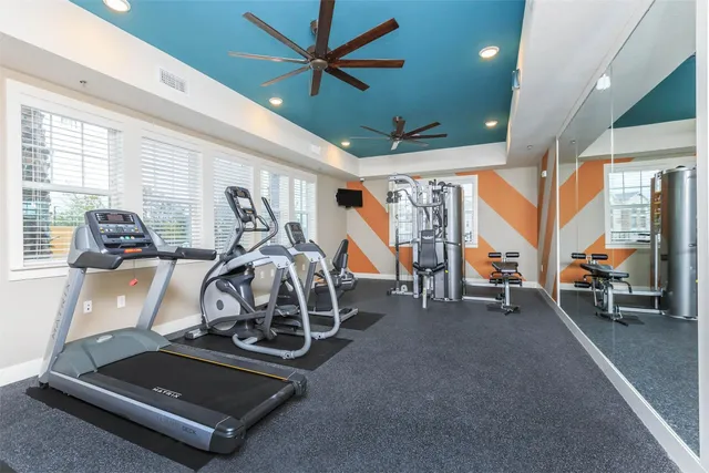 a room with furniture pool table and windows