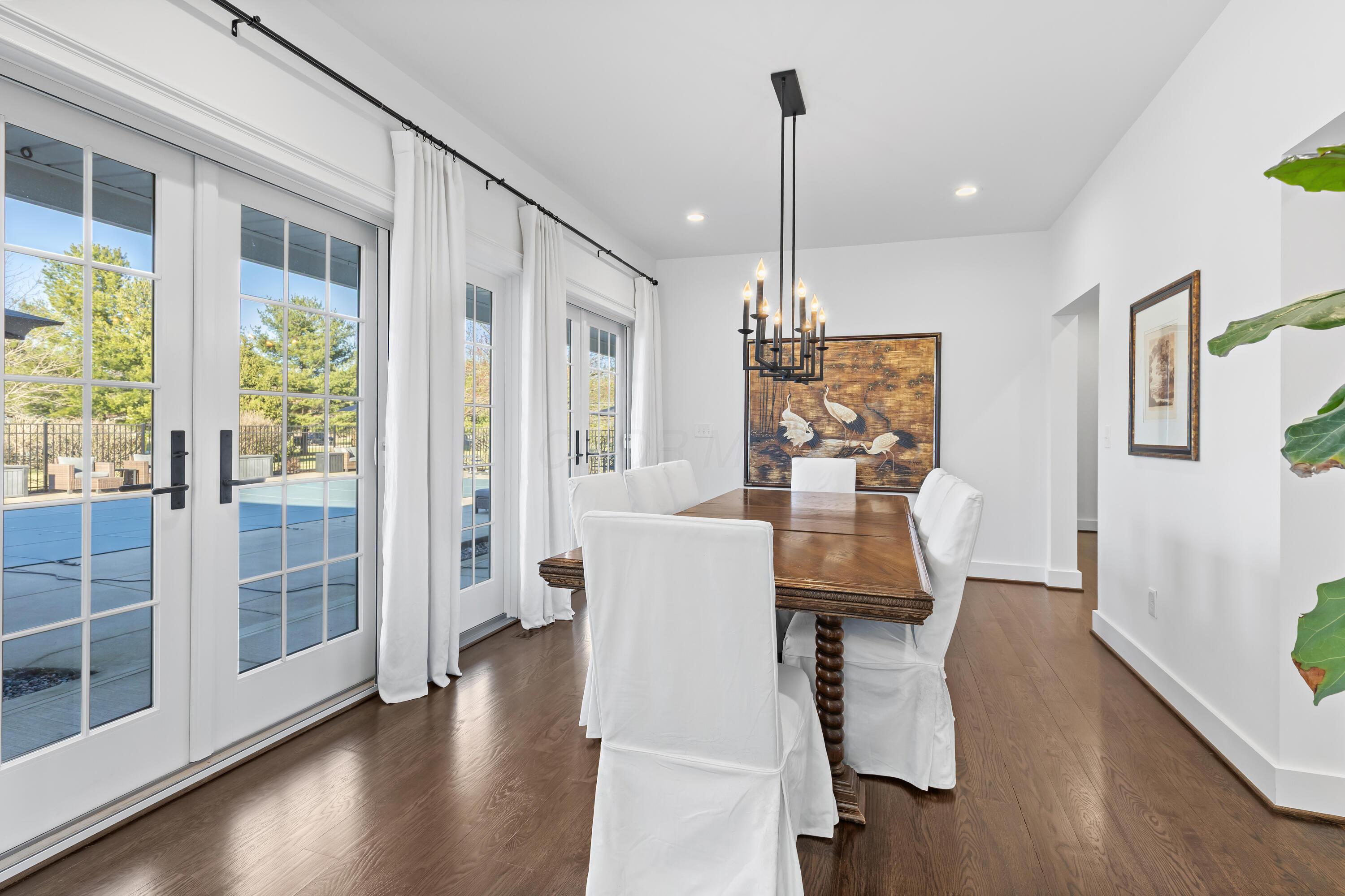 1364 Dale Ford Road Delaware, OH 43015 - Photo 20 of 112 • Hardwood flooring • White painted walls • Chandelier • Can lighting • (2) sets of french doors to covered patio