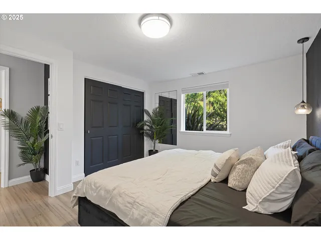 a bedroom with a bed and a window