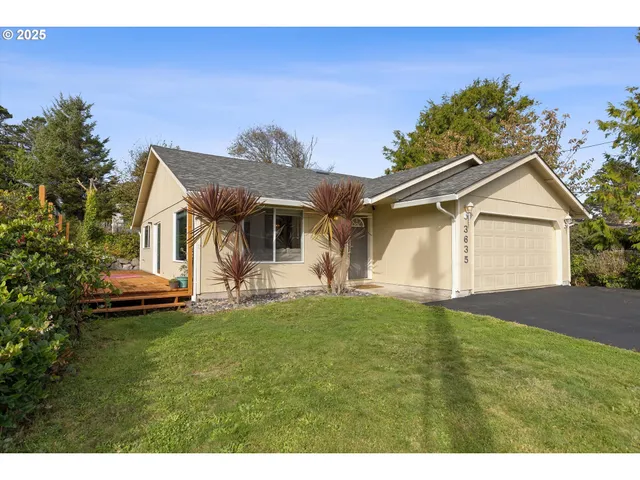a front view of a house with a garden and yard