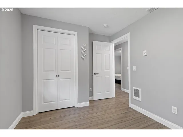 a view of an empty room and wooden floor
