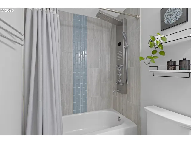 a bathroom with a shower curtain and a window