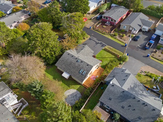 an aerial view of a house with a yard