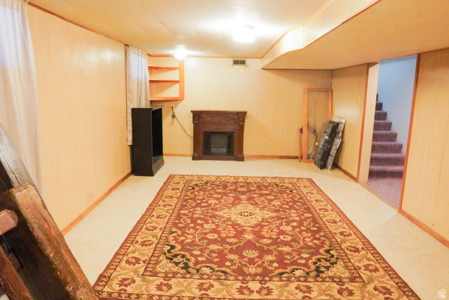 324 Stringtown Road Georgetown, ID 83239 - Photo 39 of 49 Unfurnished living room with a fireplace, stairway, and wooden walls