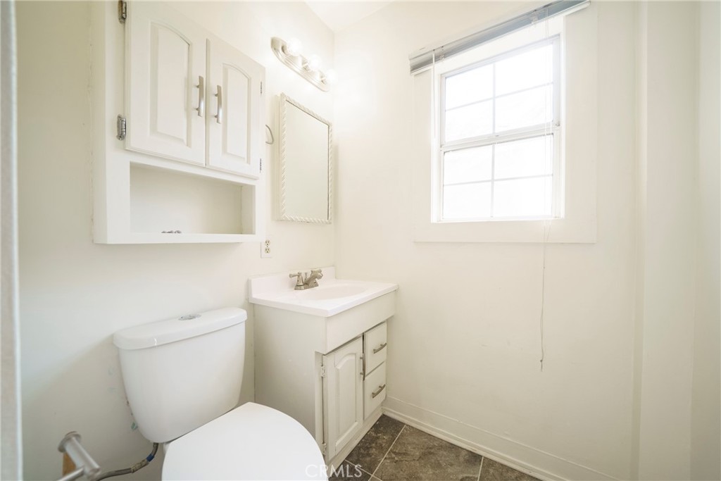 5446 Columbus Avenue Sherman Oaks, CA 91411 - Photo 19 of 31 a bathroom with a toilet sink and mirror