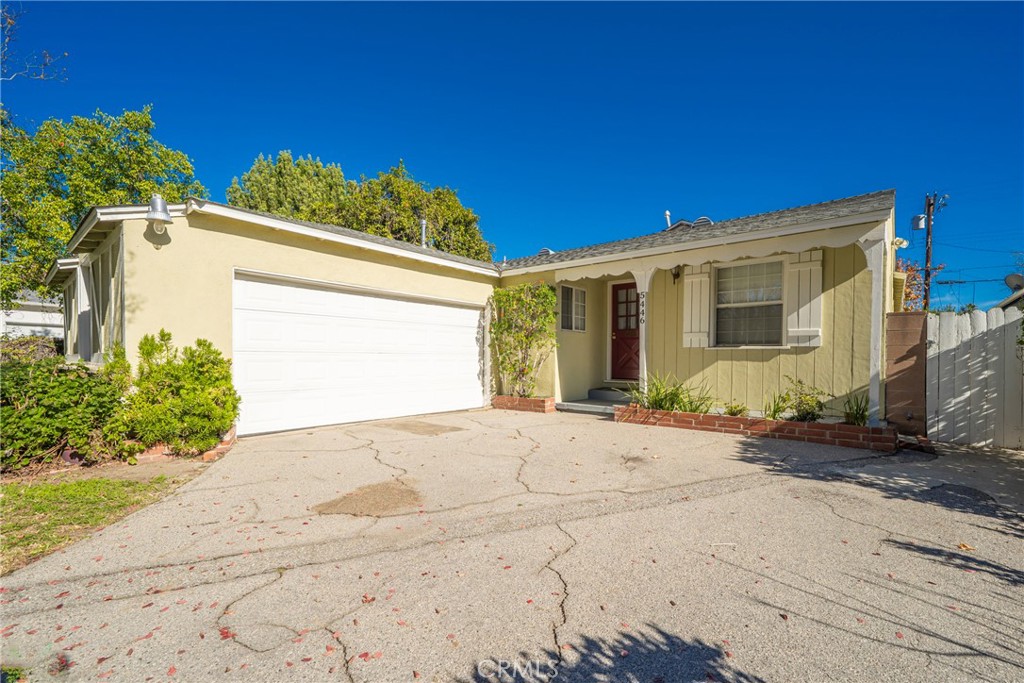 5446 Columbus Avenue Sherman Oaks, CA 91411 - Photo 3 of 31 a front view of a house with a yard and garage