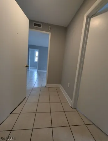 a view of an empty room and a bathroom