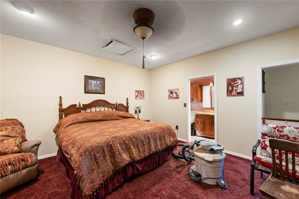 38881 Washington Loop Road Punta Gorda, FL 33982 - Photo 43 of 63 a bedroom with a bed and a flat screen tv