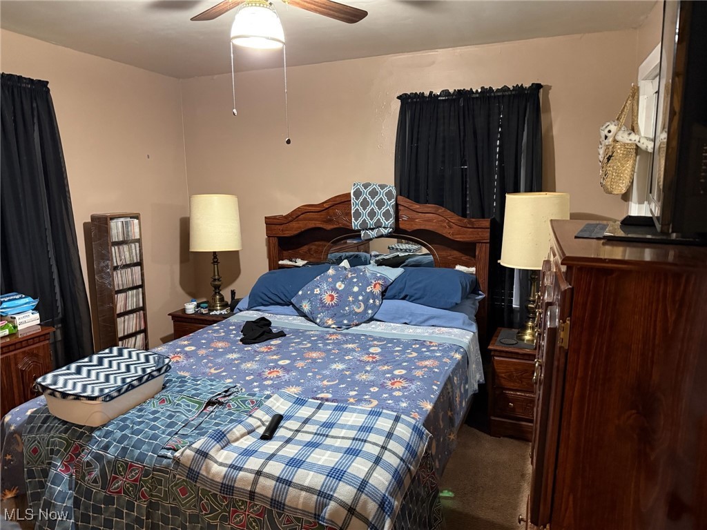 1311 Warner Road Southeast Canton, OH 44707 - Photo 5 of 14 Bedroom with dark colored carpet and ceiling fan