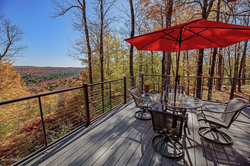 162 Stebbins Road Otis, MA 01253 - Photo 14 of 28 a view of a balcony with chairs and wooden floor