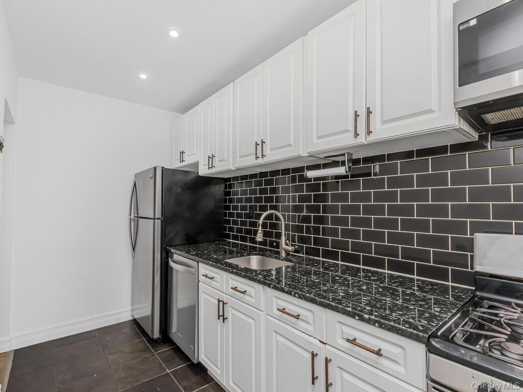 800 Bronx River Road, Unit A12 Bronxville, NY 10708 - Photo 4 of 14 a kitchen with granite countertop a sink stove and cabinets