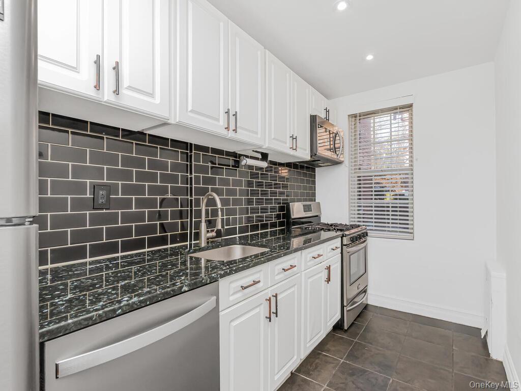 800 Bronx River Road, Unit A12 Bronxville, NY 10708 - Photo 7 of 14 a kitchen with granite countertop a sink a stove and cabinets
