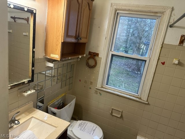 5615 Dunham Road Maple Heights, OH 44137 - Photo 12 of 29 Bathroom featuring vanity, toilet, and tile walls