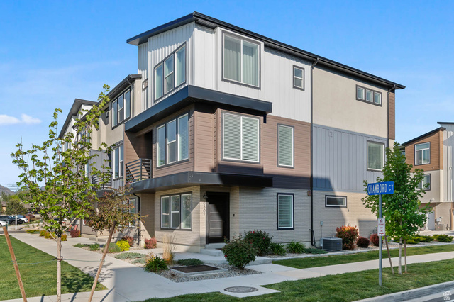 8307 Durham Street Sandy, UT 84070 - Photo 28 of 29 Contemporary multi-story facade featuring varied panel siding in white, brown, and gray tones