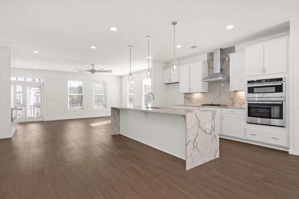 1078 Glen Opal Drive Decatur, GA 30032 - Photo 12 of 40 a large kitchen with stainless steel appliances granite countertop a large counter top a sink and a stove