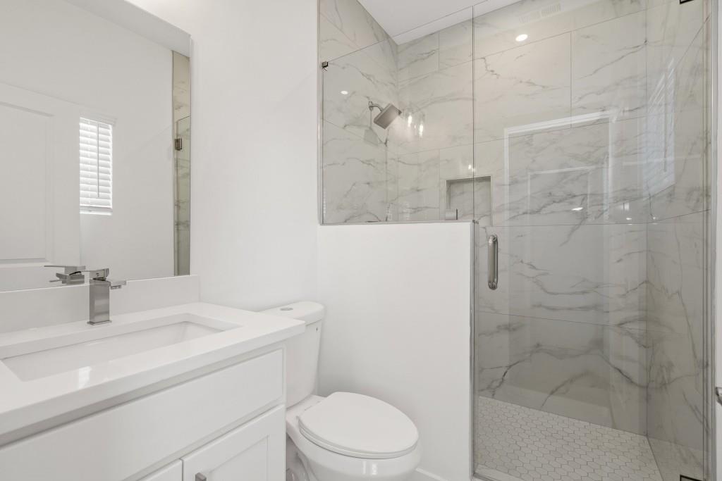 1078 Glen Opal Drive Decatur, GA 30032 - Photo 23 of 40 a bathroom with a sink a toilet and shower
