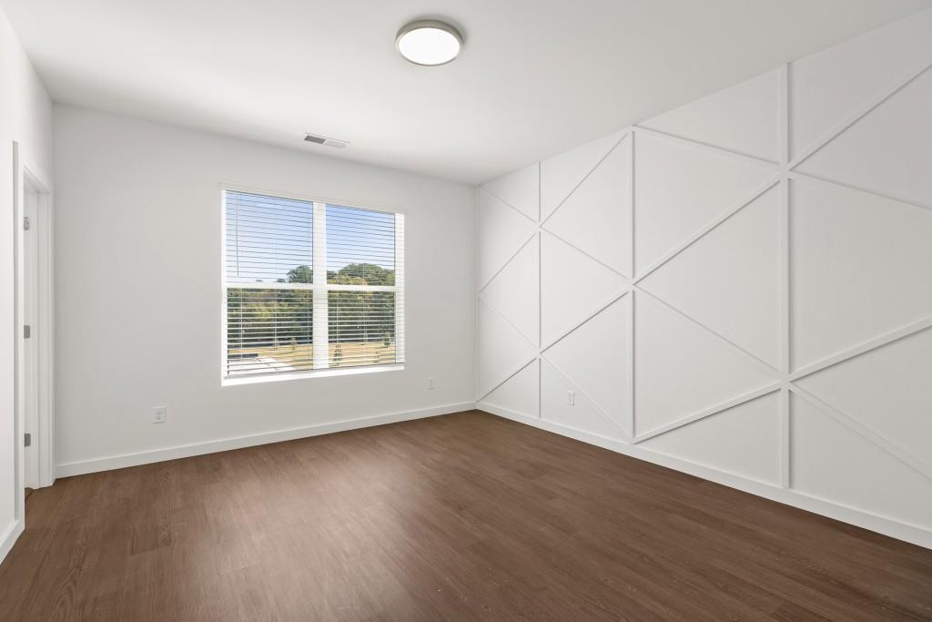 1078 Glen Opal Drive Decatur, GA 30032 - Photo 38 of 40 an empty room with wooden floor and windows
