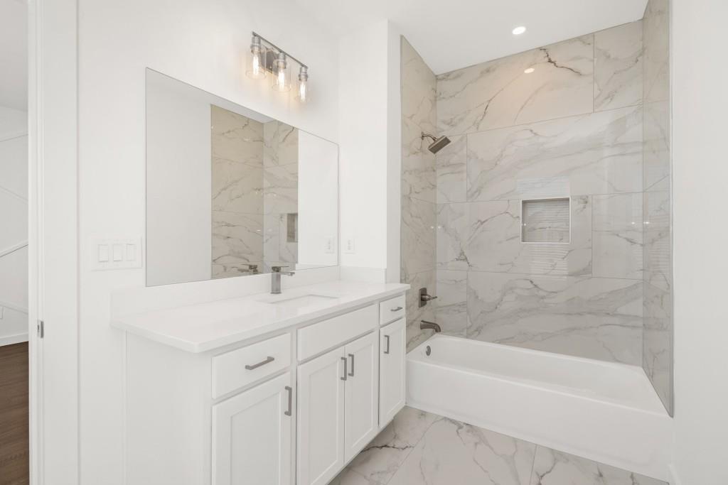 1078 Glen Opal Drive Decatur, GA 30032 - Photo 40 of 40 a bathroom with a granite countertop sink a mirror and a bathtub