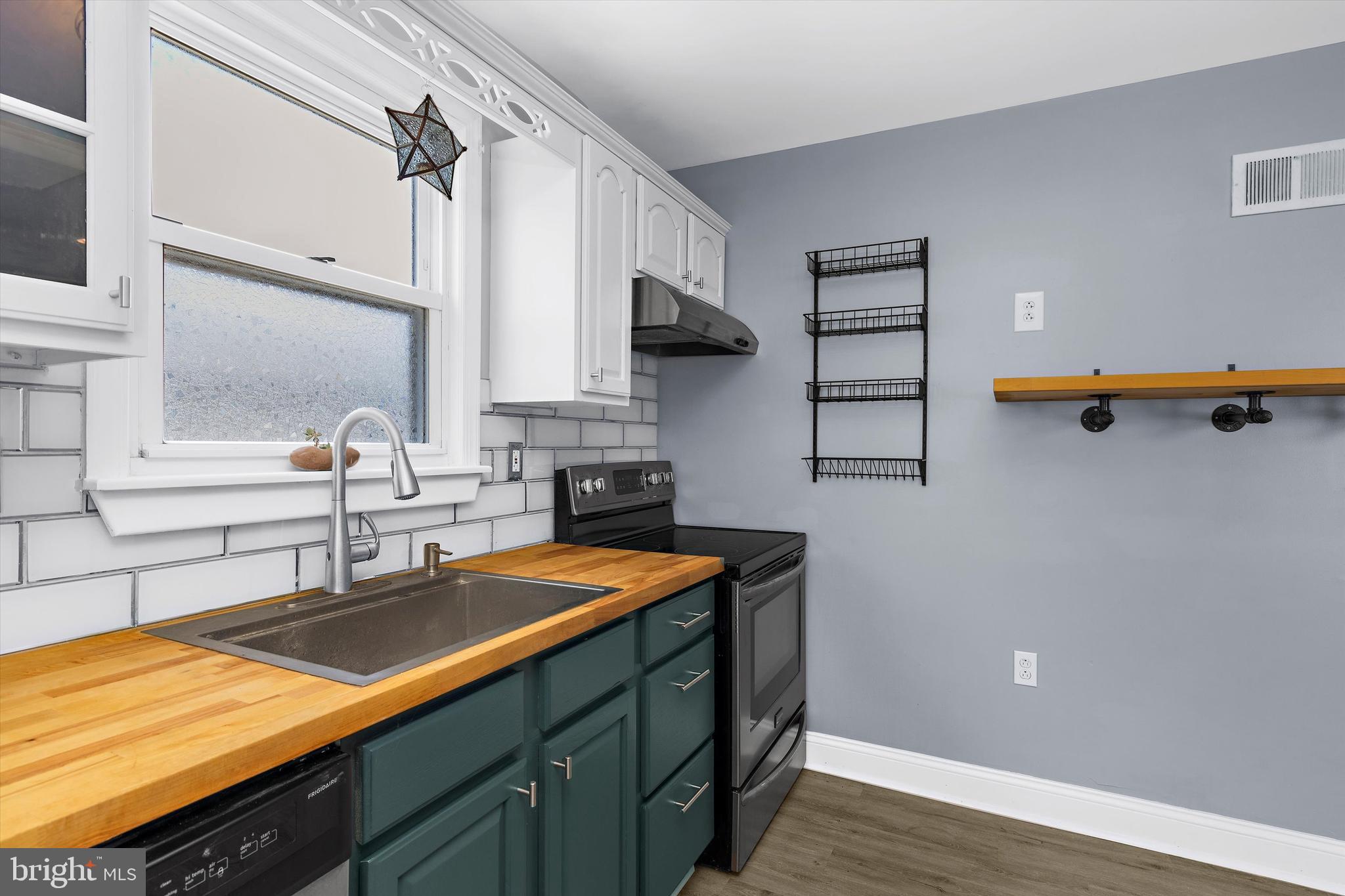 8464 Geneva Road Pasadena, MD 21122 - Photo 12 of 59 a kitchen with stainless steel appliances a sink dishwasher stove and refrigerator