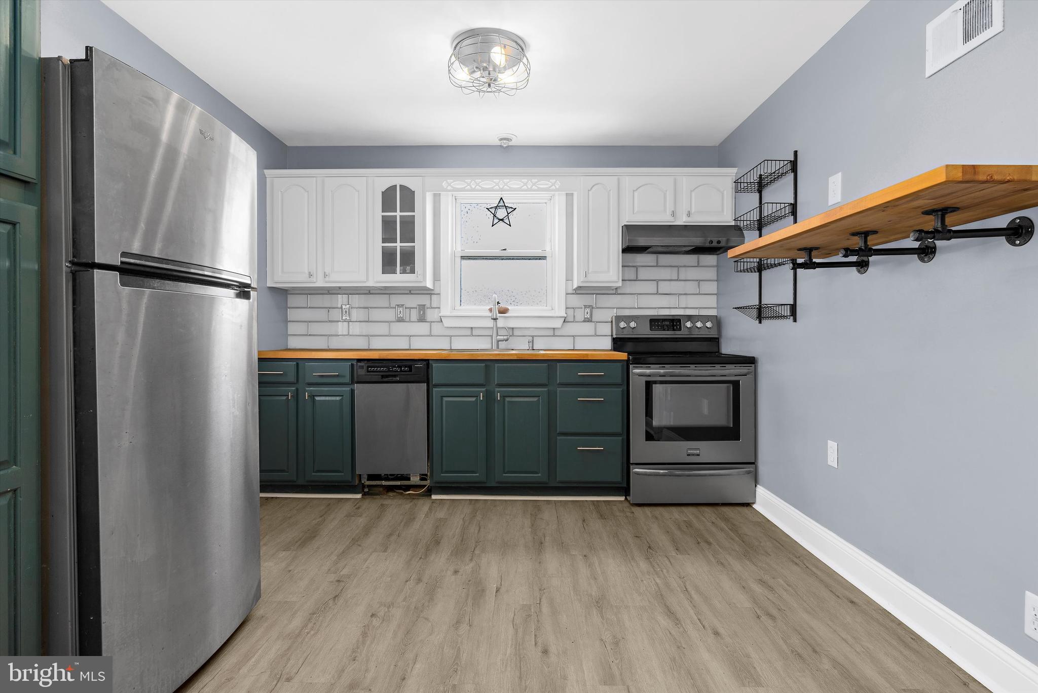 8464 Geneva Road Pasadena, MD 21122 - Photo 13 of 59 a kitchen with stainless steel appliances granite countertop a refrigerator and a sink