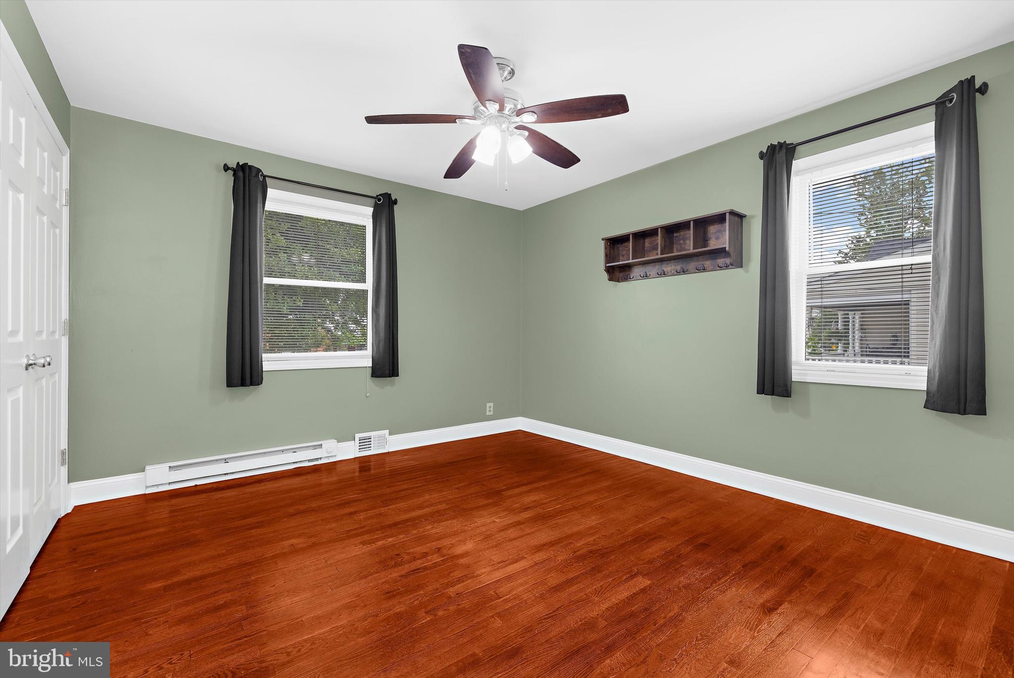 8464 Geneva Road Pasadena, MD 21122 - Photo 16 of 59 a view of an empty room with wooden floor and a window