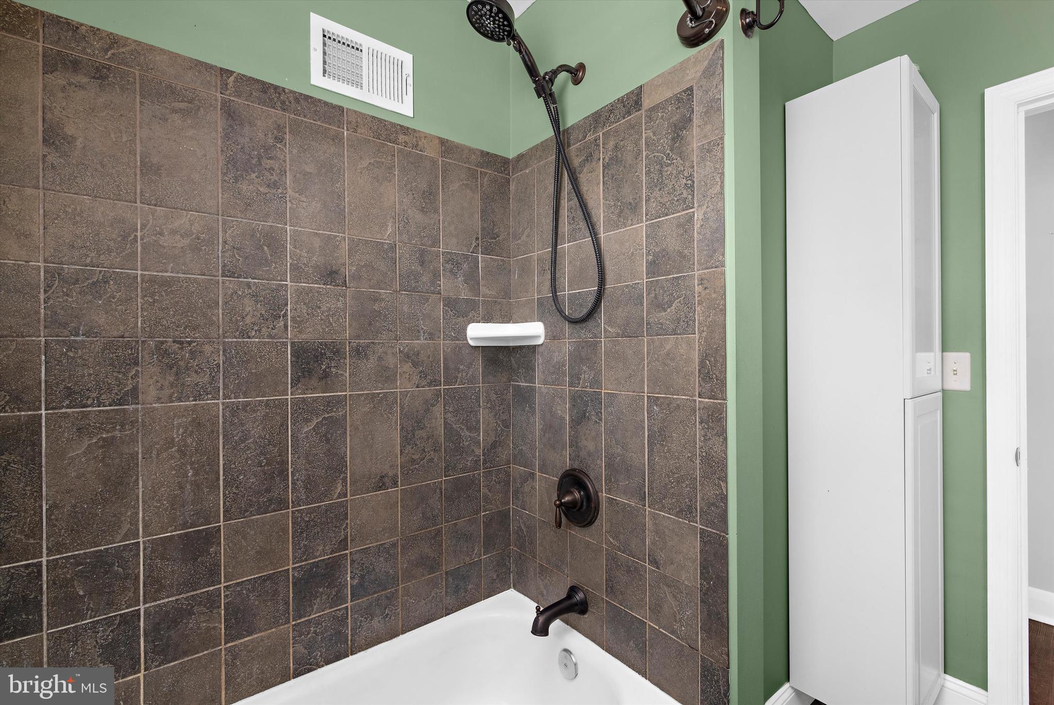 8464 Geneva Road Pasadena, MD 21122 - Photo 19 of 59 a bathroom with a shower and a sink