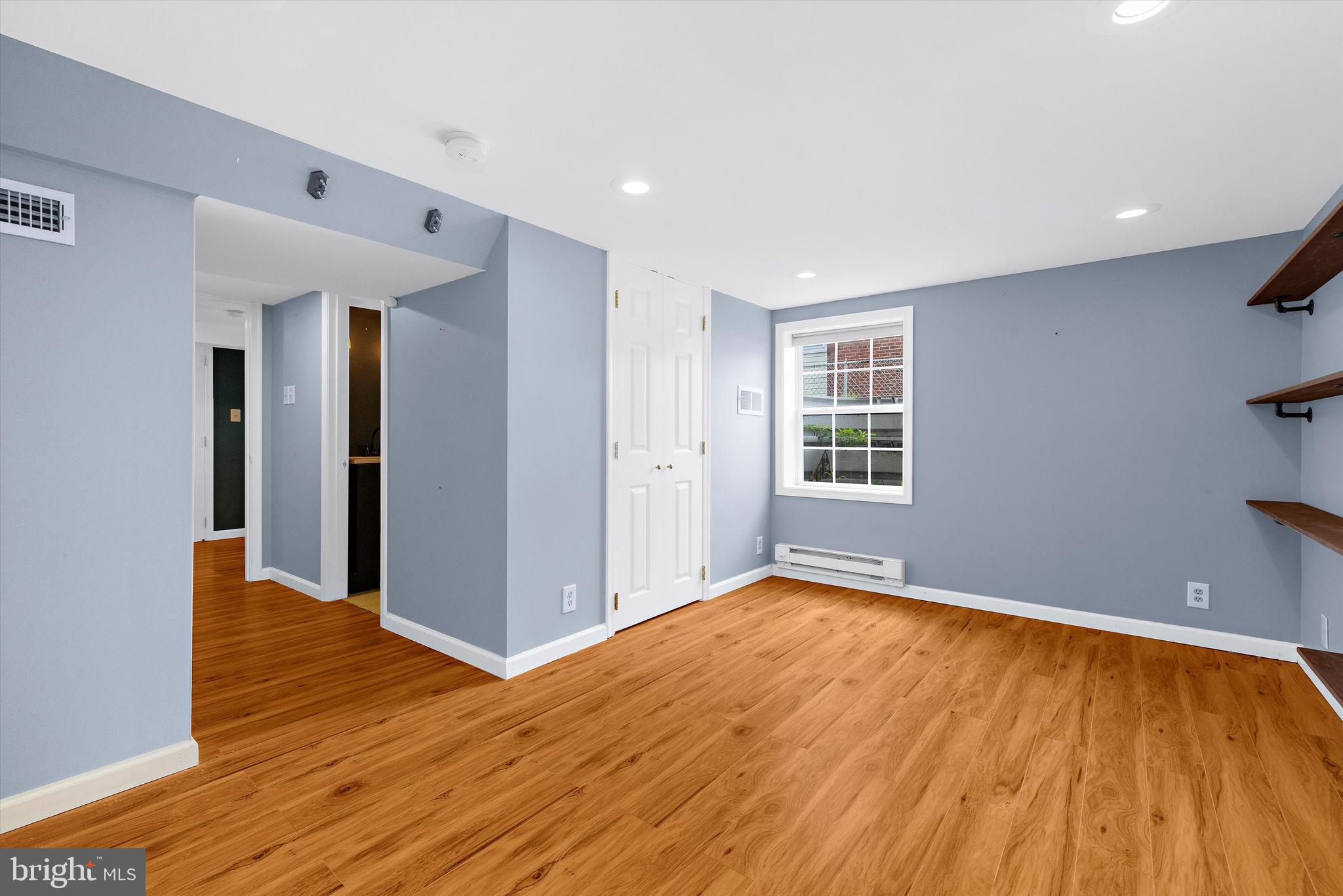 8464 Geneva Road Pasadena, MD 21122 - Photo 25 of 59 a view of an empty room with wooden floor and a window